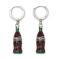 A pair of Coca-Cola glass bottle dangle earrings featuring silver-tone hoop closures on a white background.