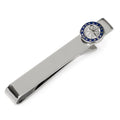 Silver tie bar with a navy blue and silver compass detail on a formal blue tie and grey suit jacket