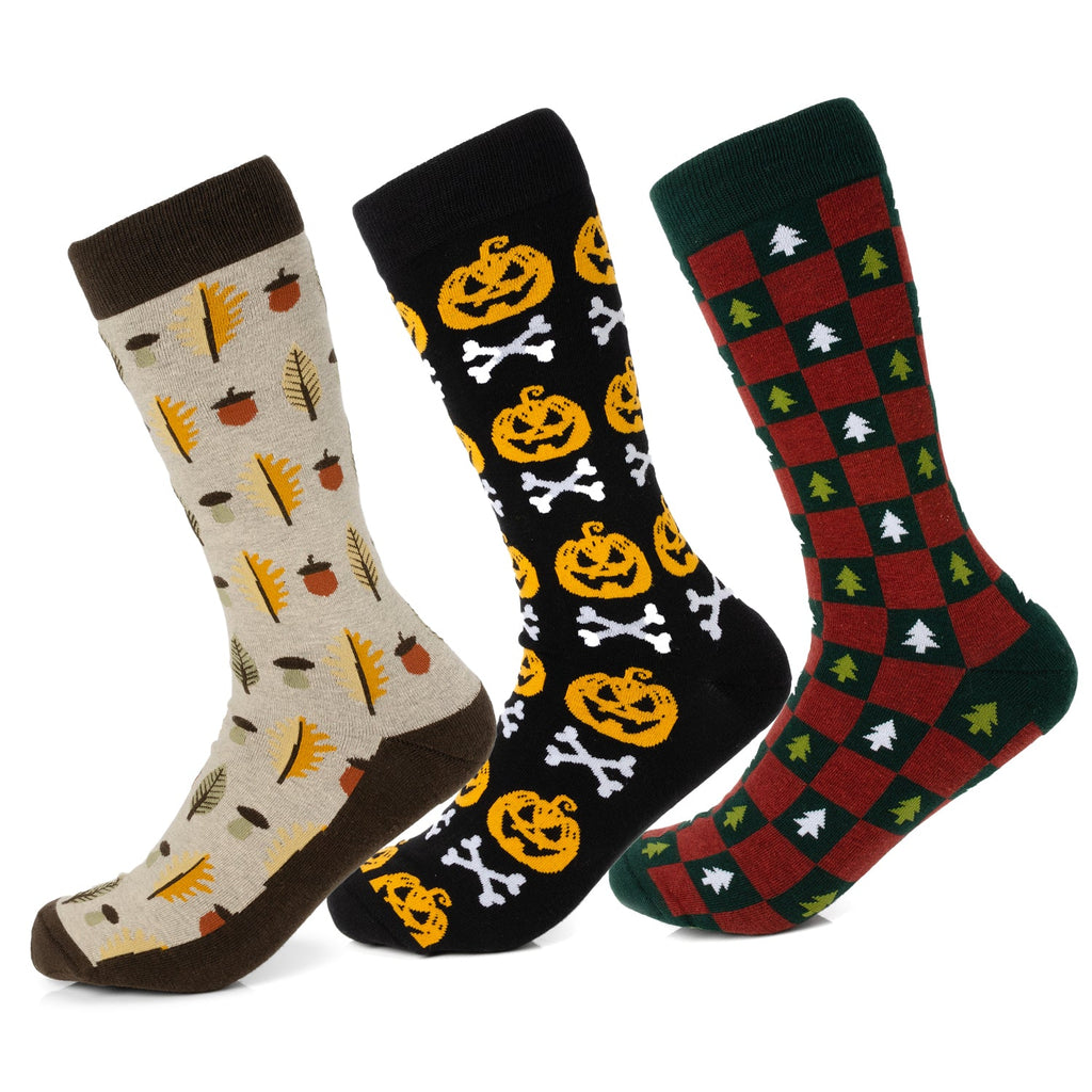 Three pairs of seasonal crew socks featuring autumn leaves, Halloween pumpkins, and Christmas tree patterns.