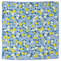 A square of fabric with a soft blue background and a pattern of bright yellow and white flowers with dark green leaves.