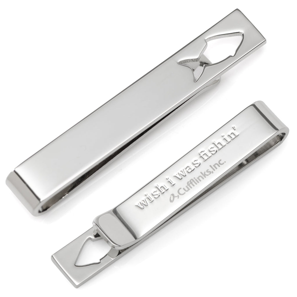 Silver tie bar with a fish-shaped cutout, shown both clipped on a navy necktie and unclipped to reveal the hidden 'Good Catch' message on the back.
