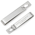 Silver tie bar with a fish-shaped cutout, shown both clipped on a navy necktie and unclipped to reveal the hidden 'Good Catch' message on the back.