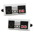 A pair of retro-inspired game controller cufflinks featuring white, black, and red details on a white background.