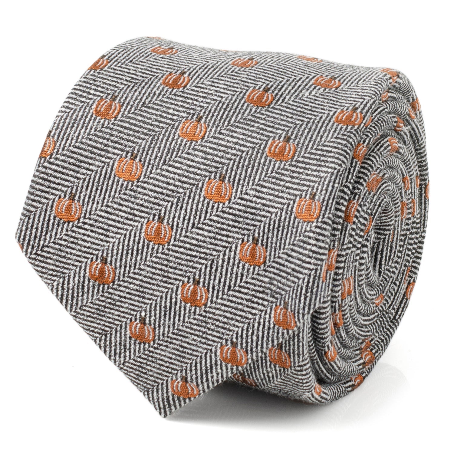 Close up of a black and white herringbone patterned necktie with small orange pumpkin motifs