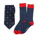 Holiday tree print necktie and matching navy blue socks with red accents in a gift box