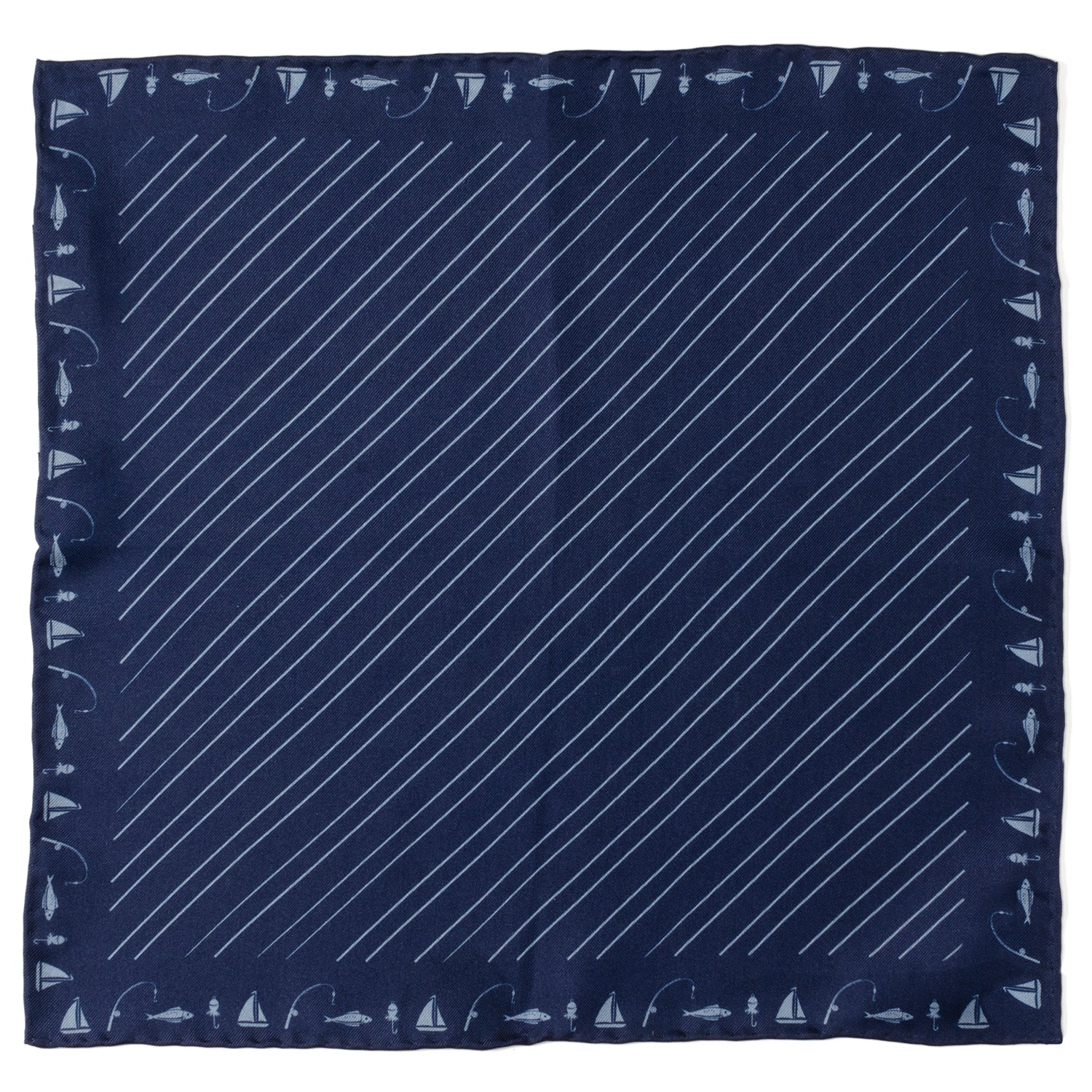 A navy blue silk pocket square with a light blue diagonal stripe and a border pattern of sailboats, fishing poles, and fish.