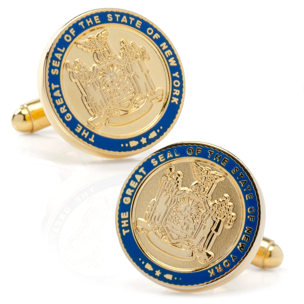 A pair of gold-tone cufflinks featuring the official New York State Seal with blue enameled borders on a white background.