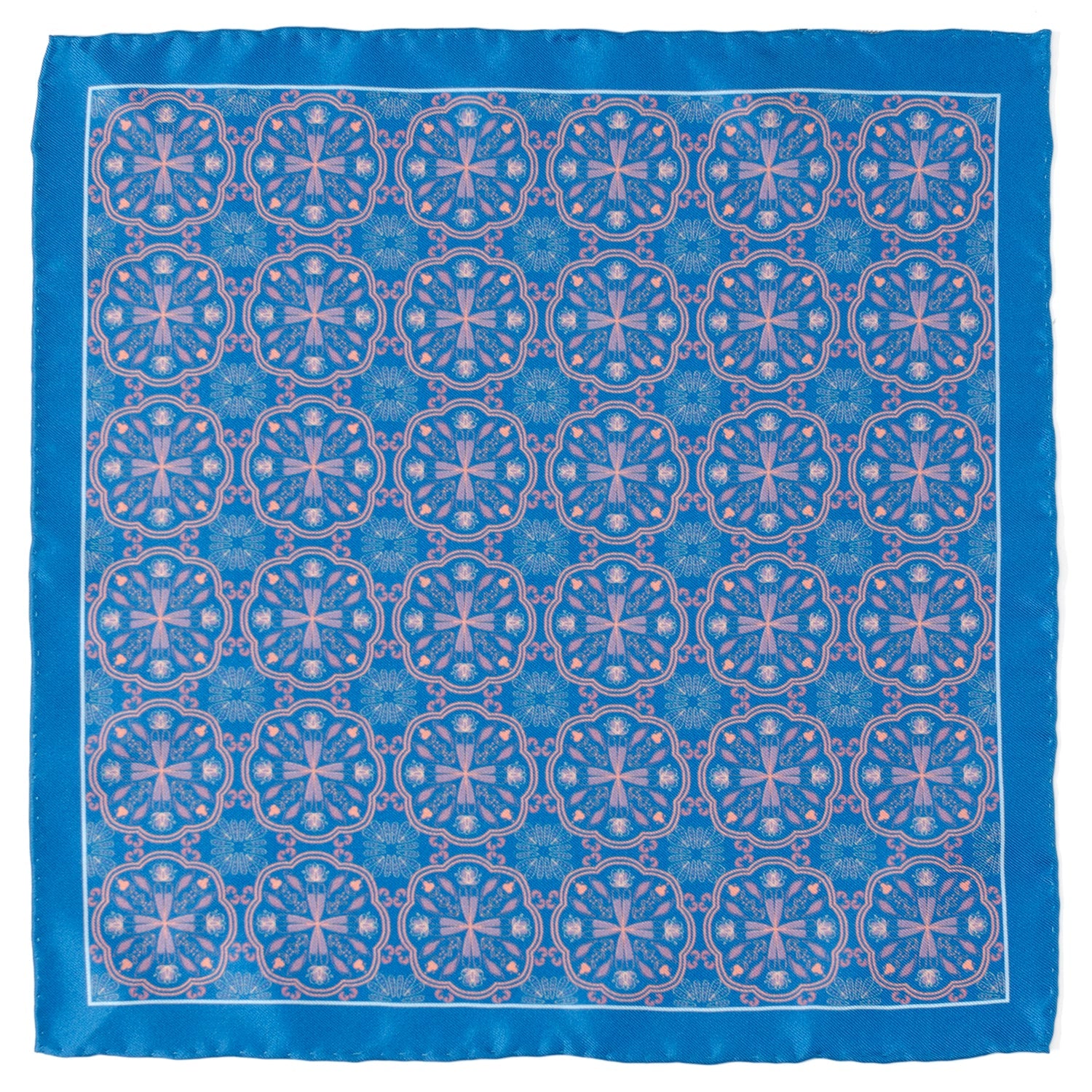 Blue silk pocket square featuring a repetitive Aboriginal-inspired pink ornament pattern folded in a suit pocket