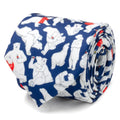 Close up of a navy blue men's necktie featuring a repeating pattern of white Coca-Cola polar bears, some wearing red scarves or holding Coca-Cola bottles.