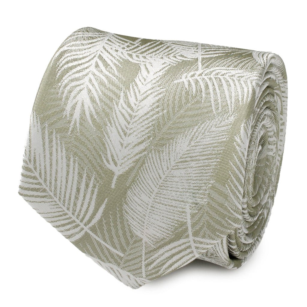 Close up of a rolled light sage green necktie featuring a subtle white palm leaf pattern