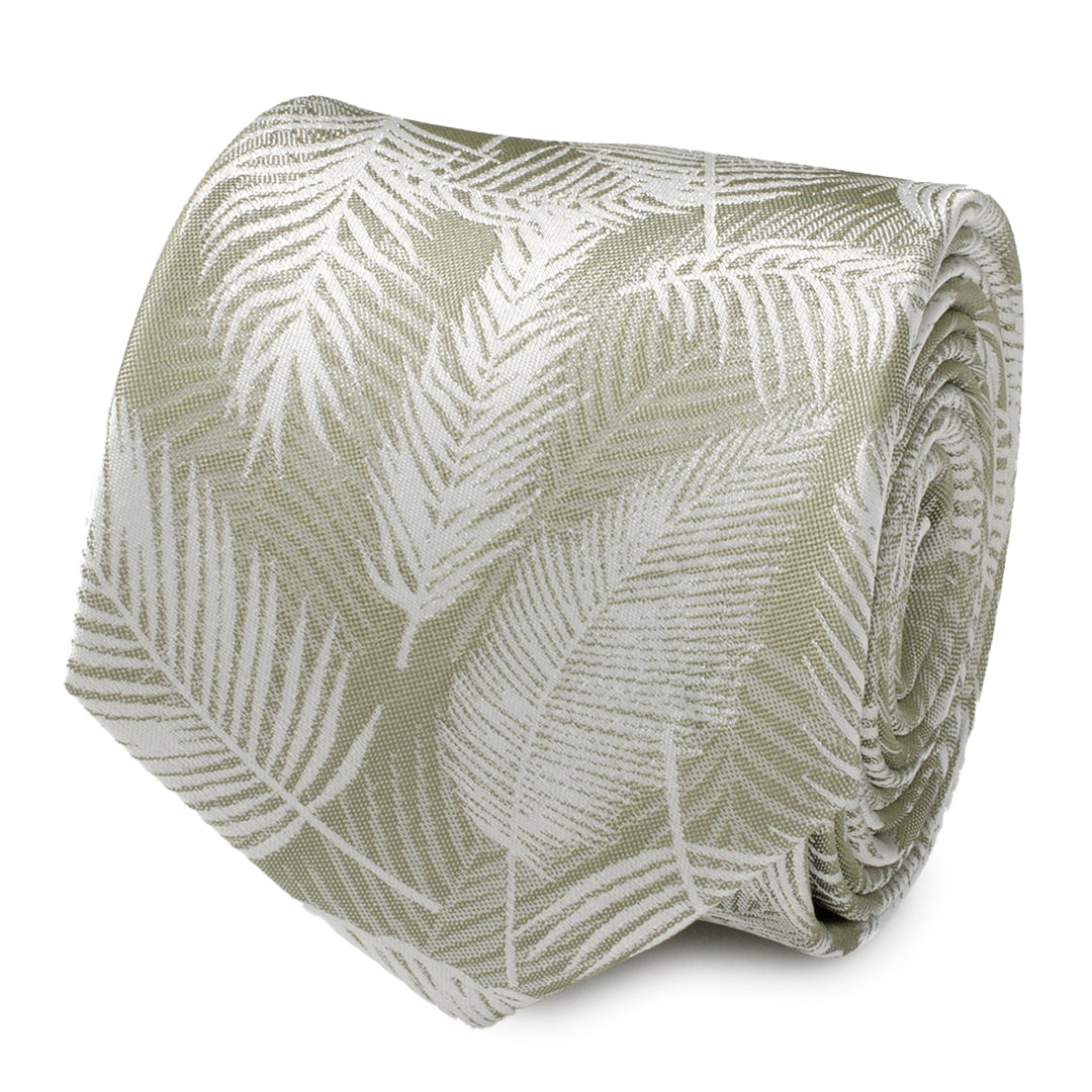 Close up of a rolled light sage green necktie featuring a subtle white palm leaf pattern