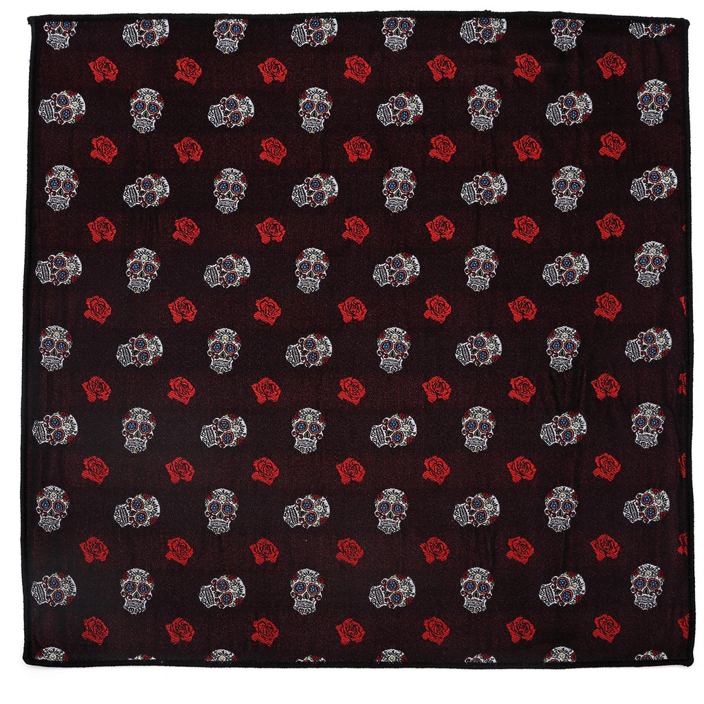 A square black silk pocket square patterned with colorful sugar skulls and red roses.