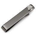 Close-up of a gunmetal Scale of Justice tie bar clipped onto a blue patterned necktie