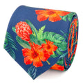 A rolled navy blue necktie with a vibrant tropical hibiscus flower and palm leaf print
