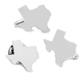 A silver Texas state shaped cufflinks and lapel pin set in a black display box.