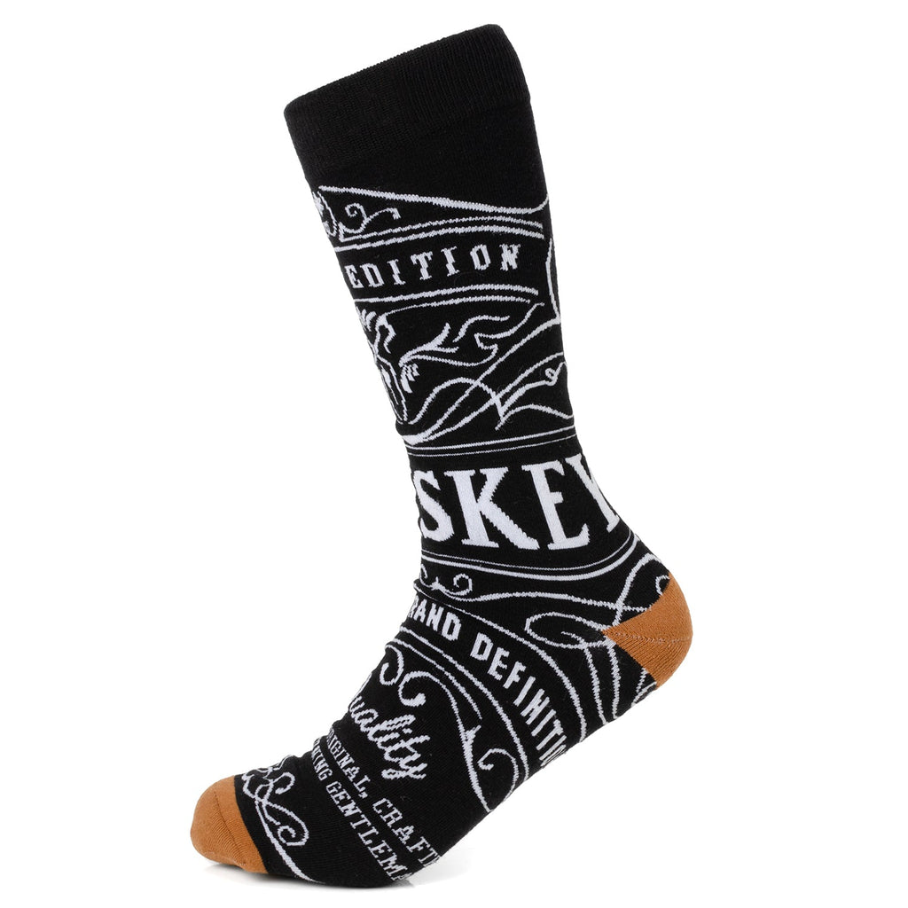 A pair of black crew socks featuring white graphic whiskey-themed text and tan colored heel and toe details.