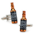 A pair of novelty whiskey bottle shaped cufflinks with a black label design and copper finish