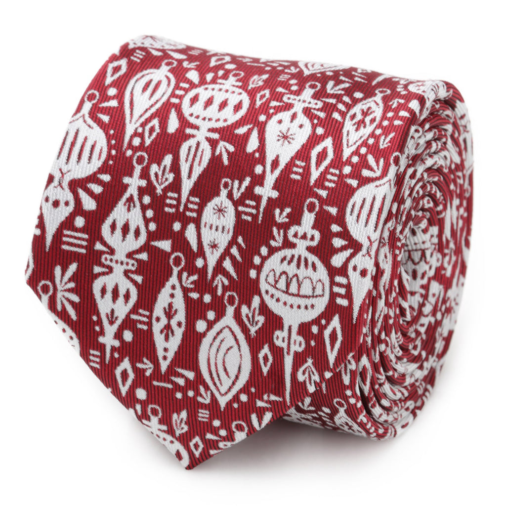 Close-up view of a red men's necktie featuring a white Christmas ornament pattern, shown rolled up.