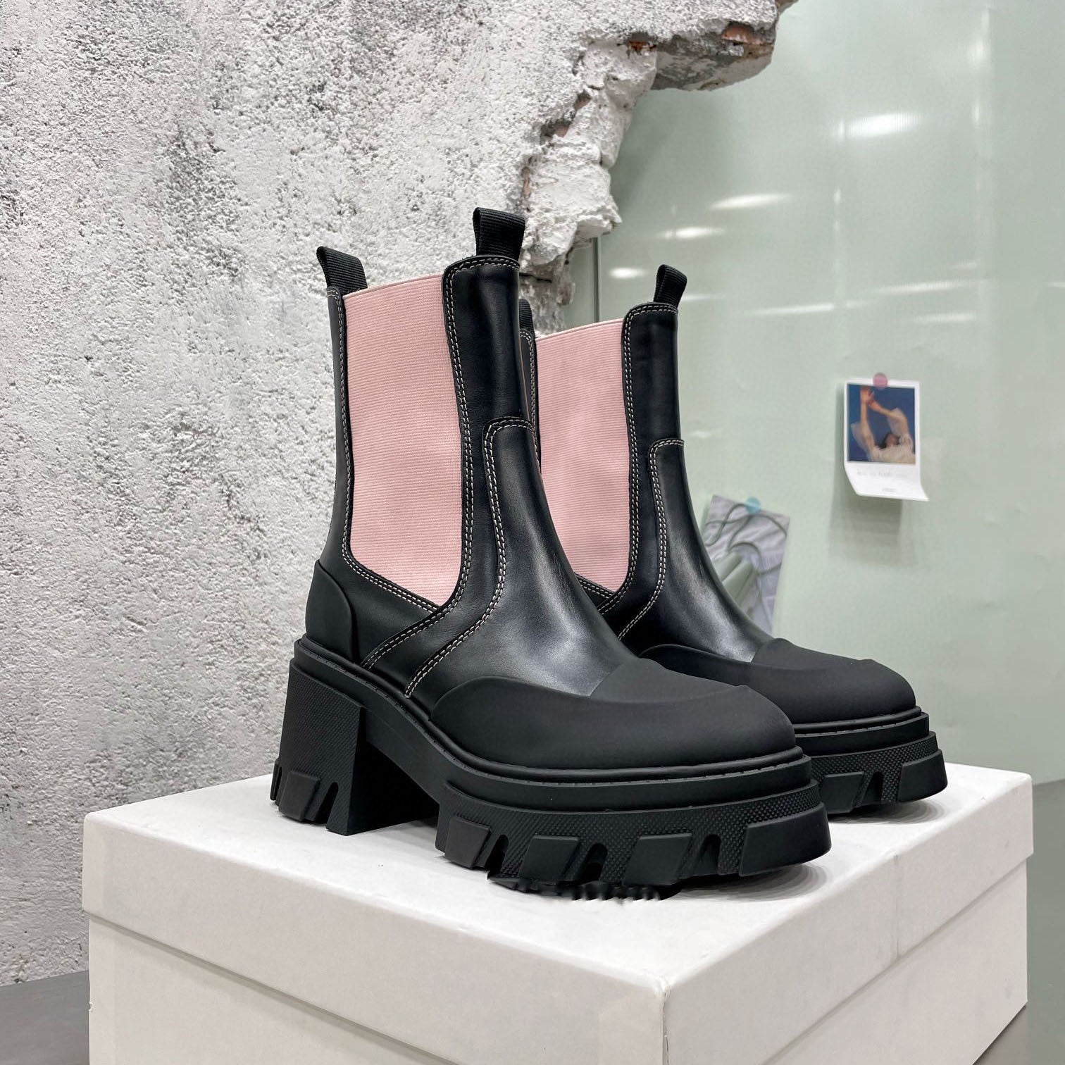 Women's black platform Chelsea boots with thick sole and elastic side panels.