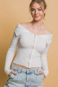 Model wearing a white ribbed bardot long sleeve top with a front zip closure.