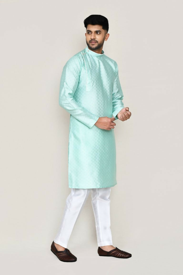 Close up of green jacquard silk kurta with straight fit pants showing intricate fabric detail