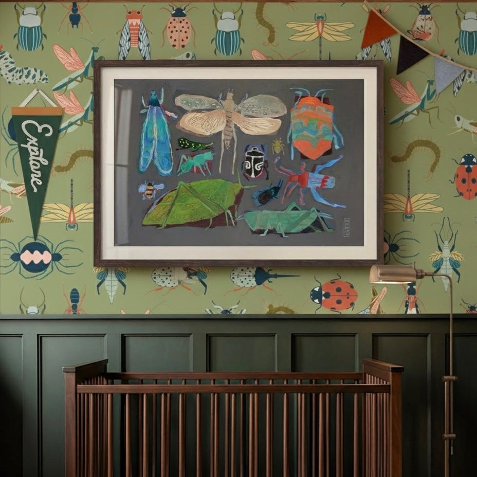 Close up of Flick wallpaper featuring vibrant insect illustrations on a sage green background in a modern home office.