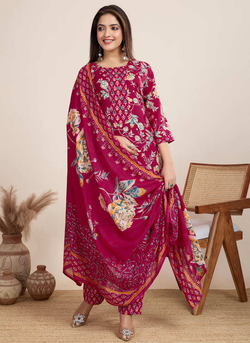 Woman wearing a pink printed cotton blend salwar suit with matching pants.