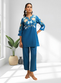 Elegant teal silk cord set with intricate embroidery and a split V-neckline