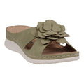 Side view of a pair of women's green sandals featuring a large flower rosette on the strap and a comfortable white cushioned sole