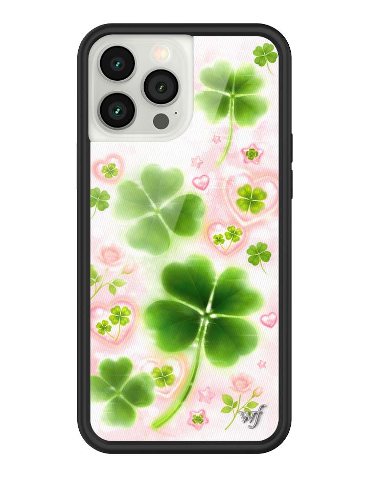 Phone case with green four-leaf clovers on a pink floral background