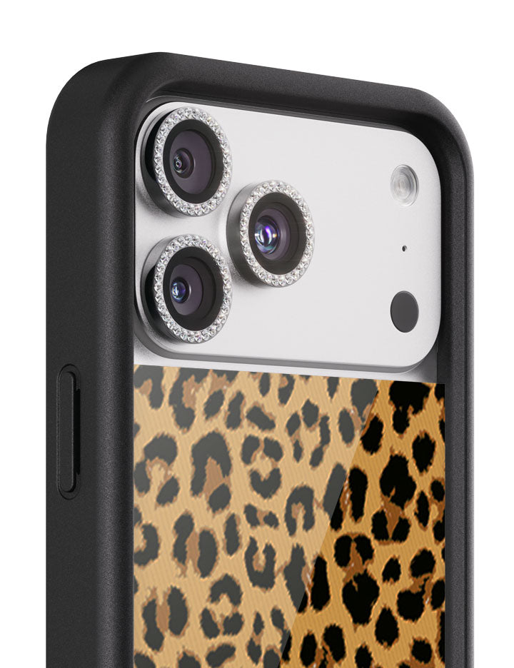 Close up of black rhinestone camera lens protectors attached to an iPhone