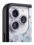 Close up of purple crystal-studded camera lens protector rings on an iPhone camera module.