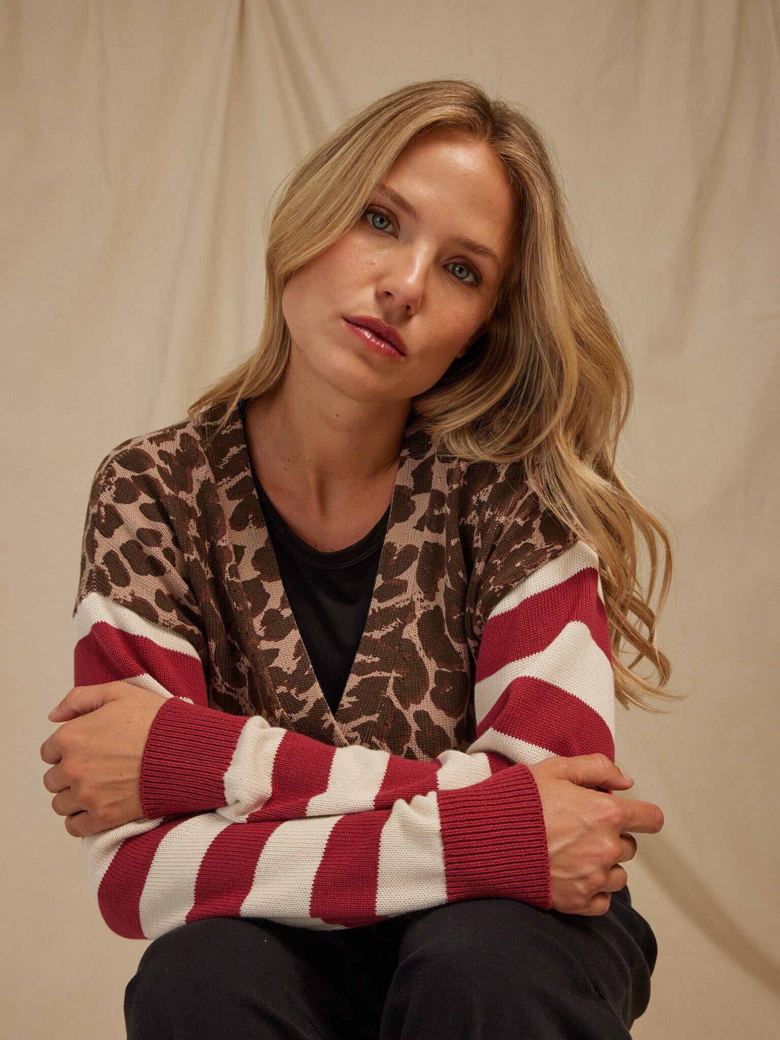 Close-up of the Cicely Print Stripe Mix Sweater Knit Cardigan showing the button-front closure and stripe-animal print pattern.