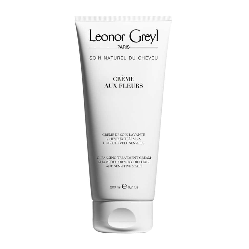 White bottle of Leonor Greyl Crème aux Fleurs cleansing treatment for dry hair
