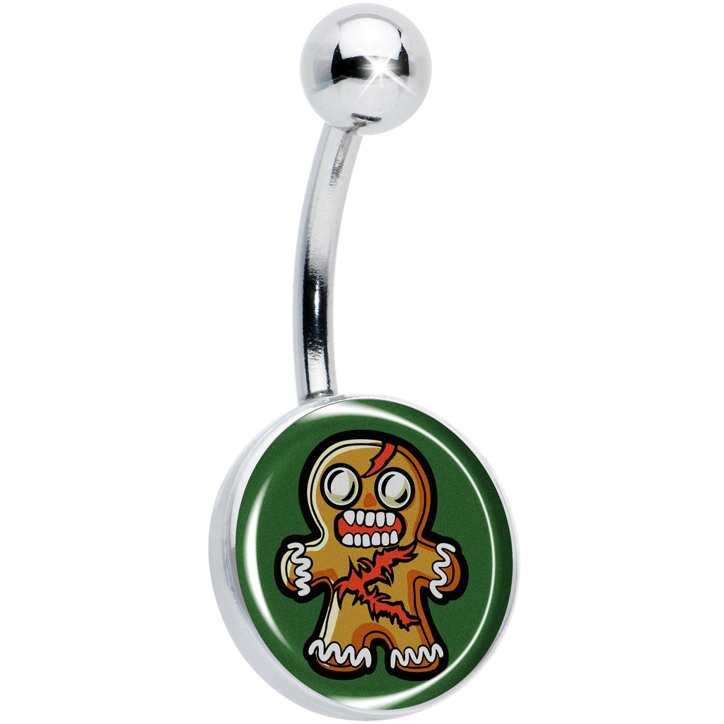 Close up of a silver-tone belly button ring featuring a zombie gingerbread man graphic on a green background.