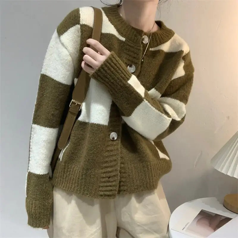 Woman wearing a loose-fit olive and white checkered knit button-up cardigan sweater