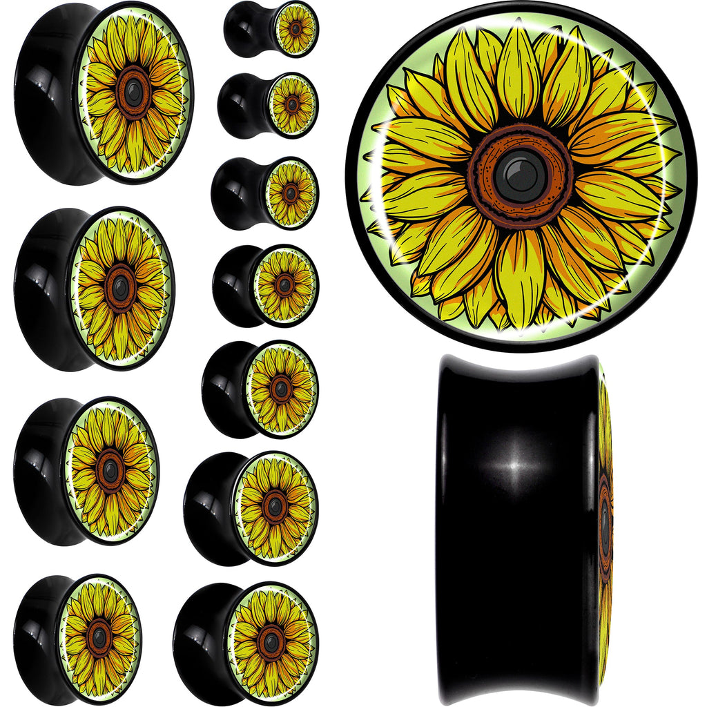 A pair of yellow sunflower print saddle plugs made from black acrylic material.