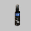 Calm Down Spray 2oz bottle featuring a sleek black design with blue text branding.