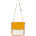 A medium-sized leather envelope crossbody bag in a color-blocked design of yellow, beige, and white with an adjustable strap.