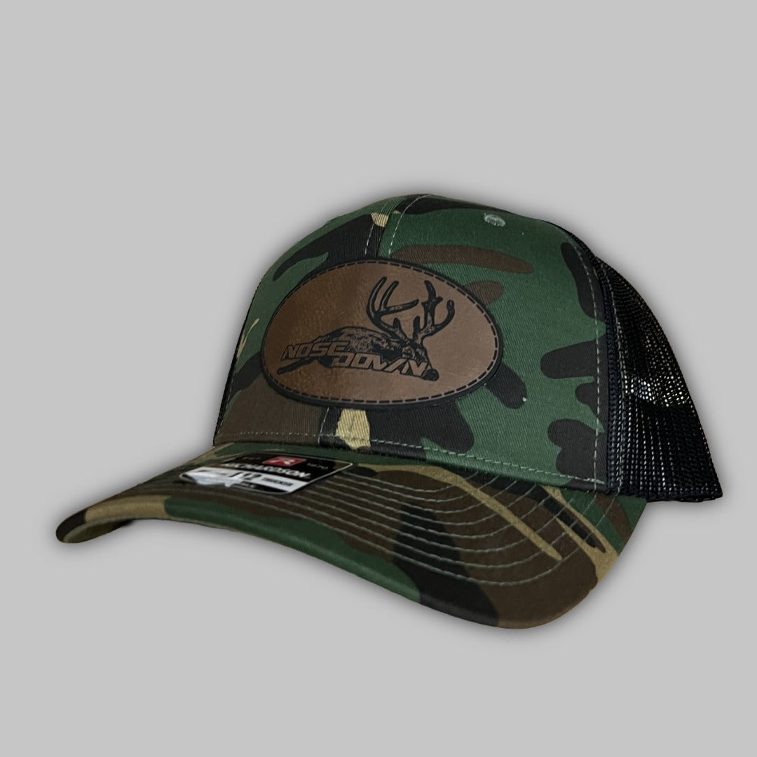 Dead Buck oval patch trucker hat with breathable mesh back and rugged design.