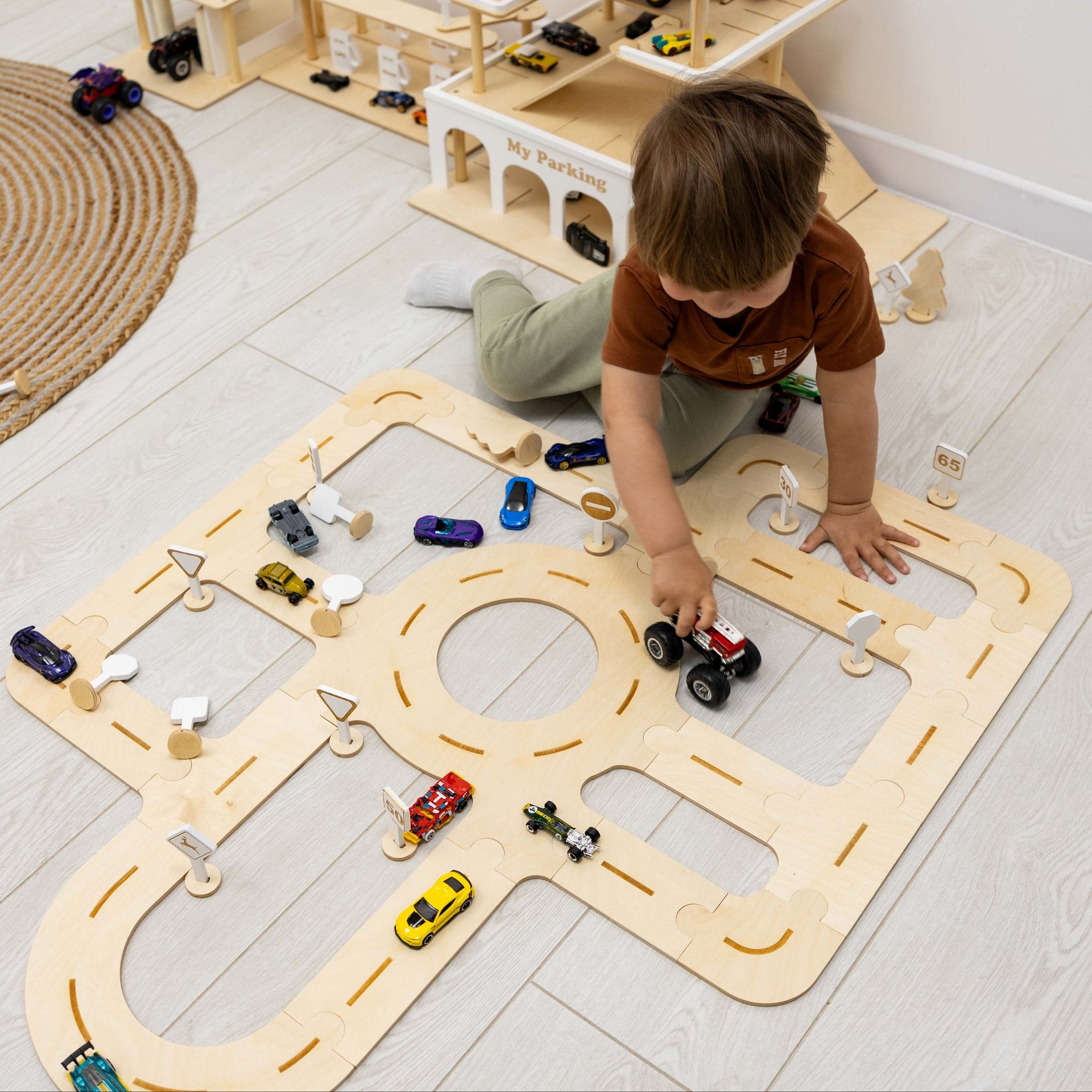Handcrafted wooden car track toy on a clean surface for toddler playtime