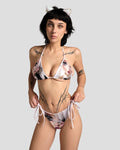Woman wearing Kitty.exe bikini set with digital cat girl graphic print in pink and multi-color polyester fabric
