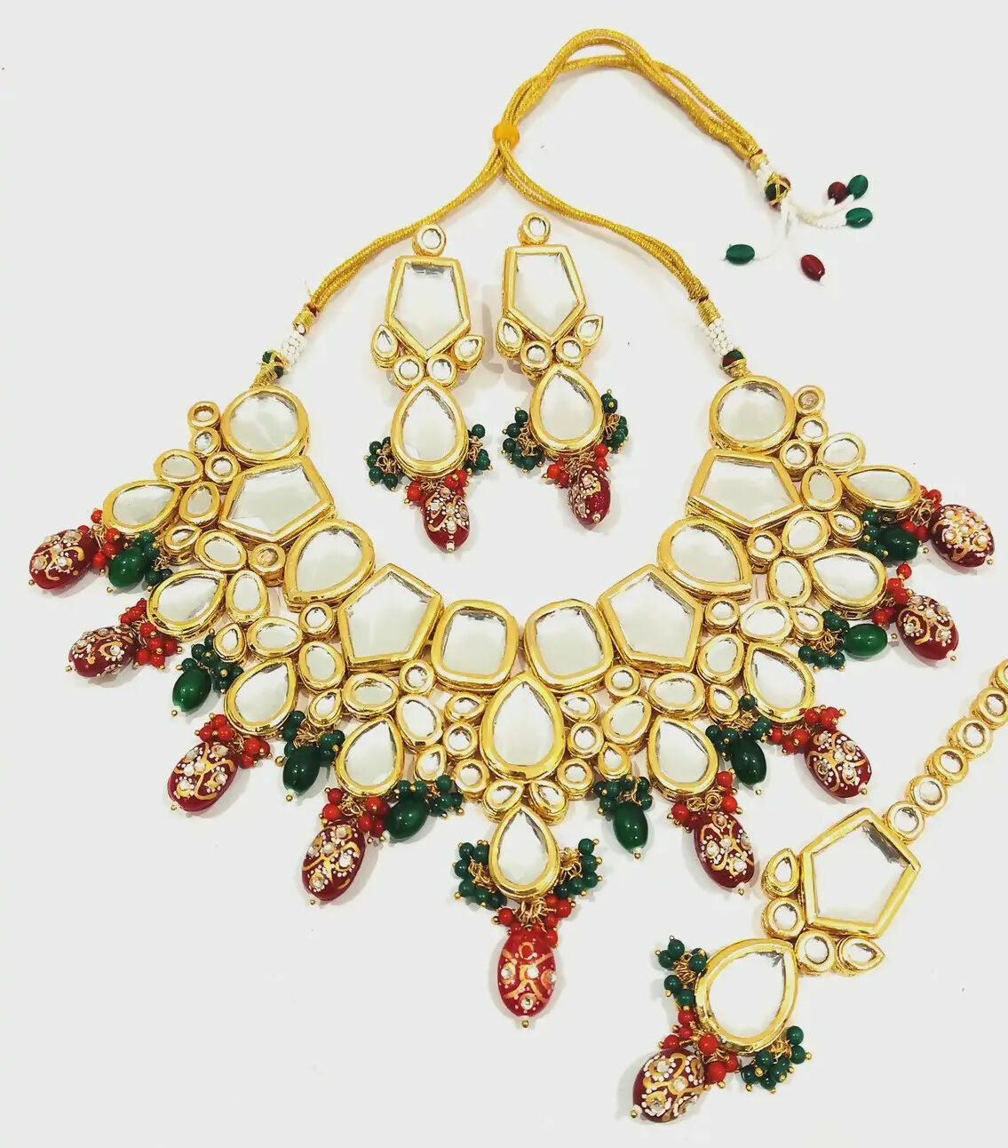 Handcrafted gold-plated Kundan jewelry set with intricate stone-studded design