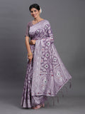 Muted violet linen cotton saree with white decorative patterns and red and green accents