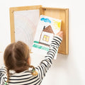 A modern, changeable wooden artwork frame displaying a child's drawing on a wall