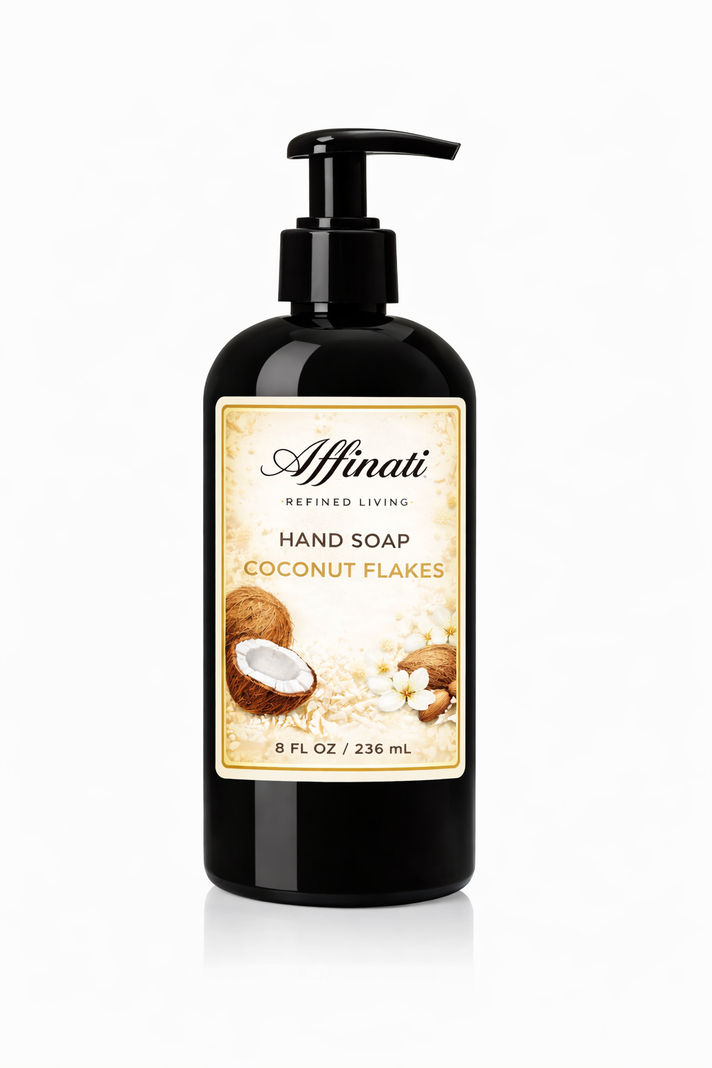 A black pump bottle of Coconut Flakes hand soap with a decorative cream-colored label featuring coconut and flower imagery.