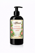 A black pump bottle of Peppermint Swirl liquid hand soap featuring a festive holiday label with holly and candy canes.