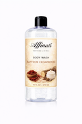 A clear plastic bottle of Saffron Cedarwood Body Wash featuring a label with images of saffron threads and cedar wood, 16 oz size.