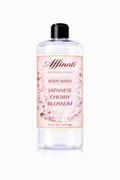 A 16 oz clear bottle of Japanese Cherry Blossom Body Wash with a floral label featuring pink cherry blossoms against a white background.
