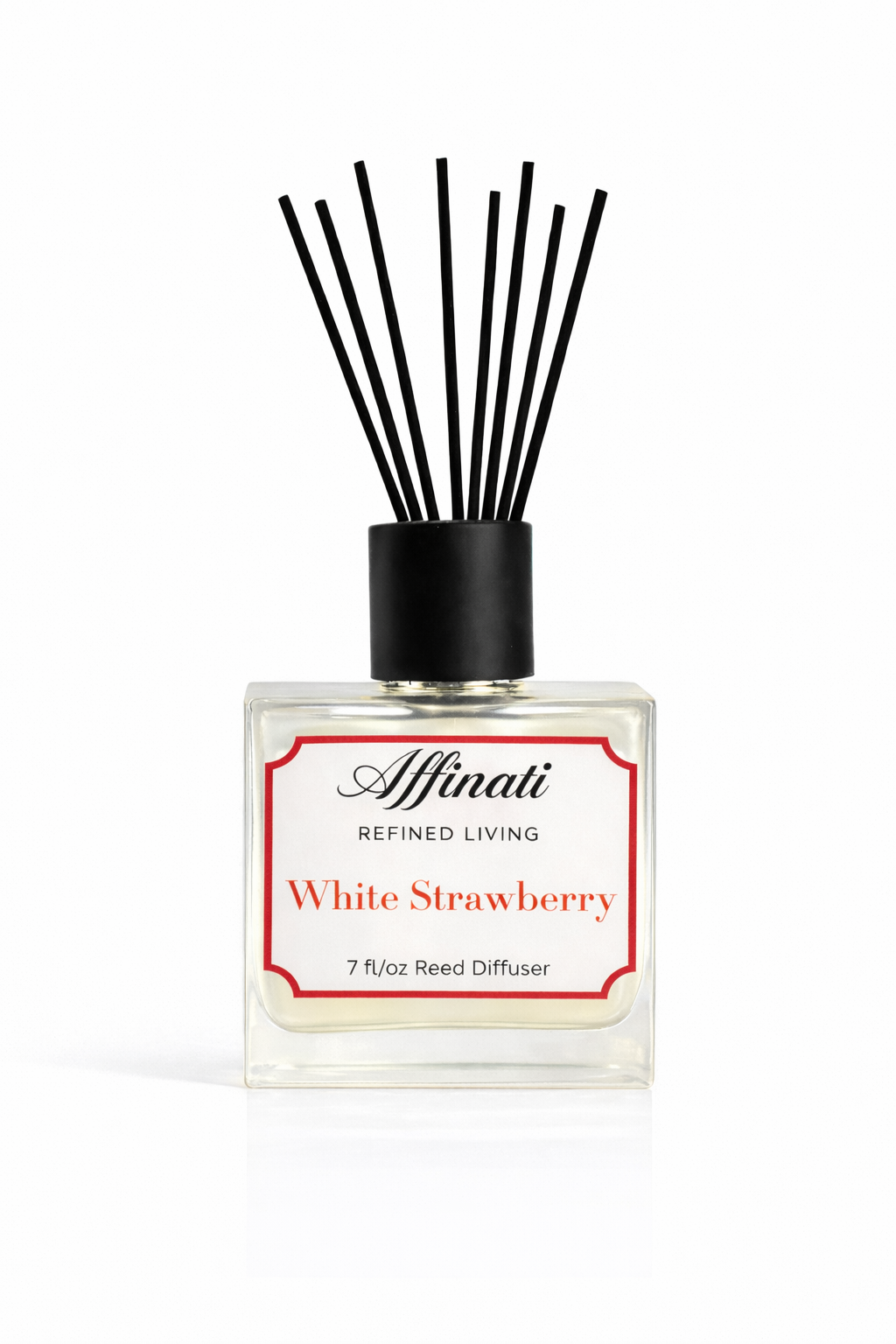 White Strawberry reed diffuser in a clear glass bottle with black reeds.